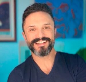 marc scheff headshot with blue background